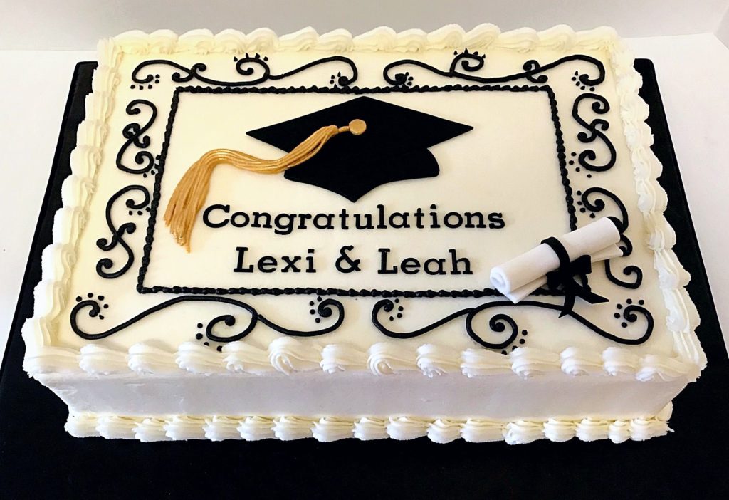 a graduation cake with a cap and a diploma