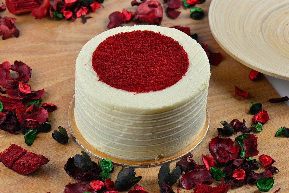 Red and white cake near a roses