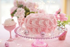 A pink cake on a pedastool